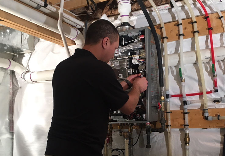 Man working on repairing a water heater