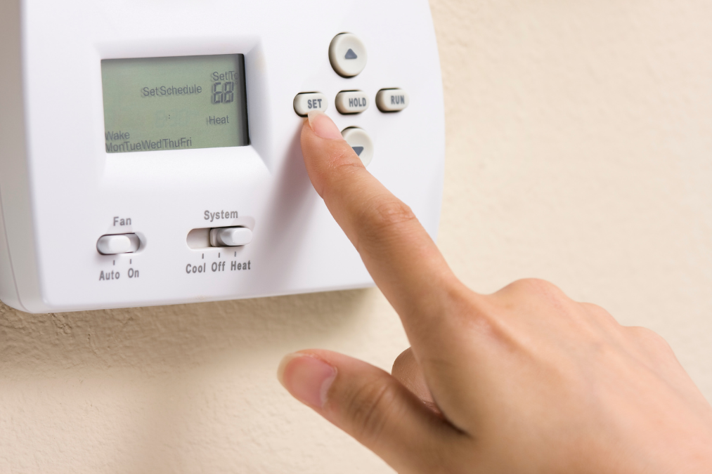 Person setting a thermostat