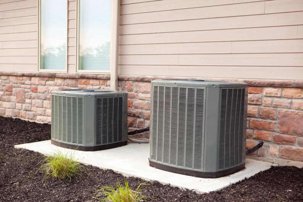 a couple of air conditioners outside of a house