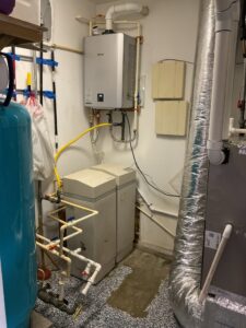 a water heater and a tank in a room