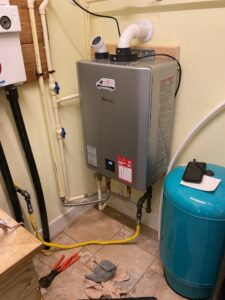 a water heater sitting in the corner of a room