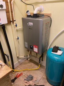 a water heater sitting in the corner of a room