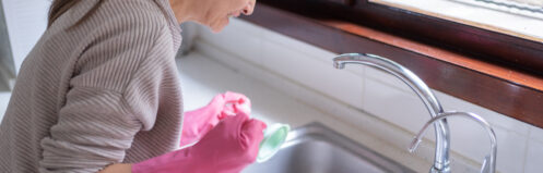 Homeowner looking at clogged kitchen drain